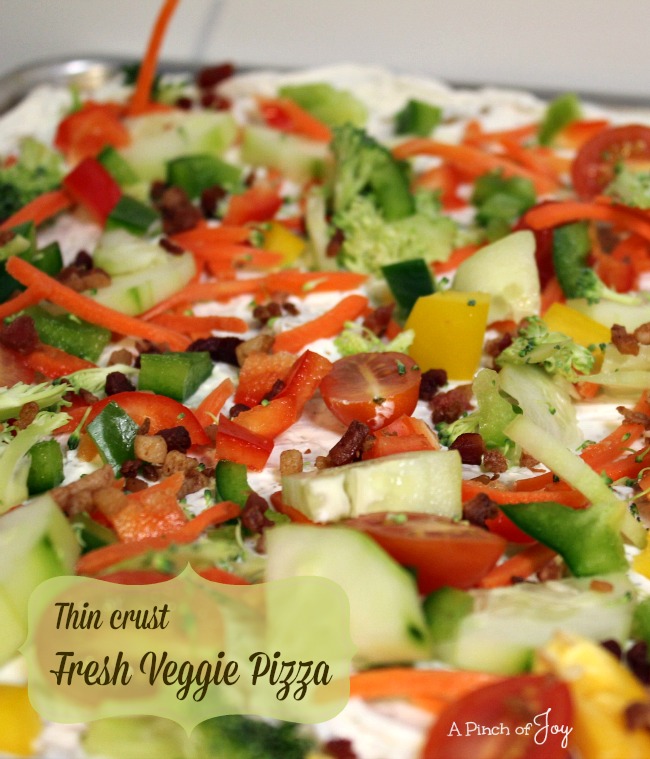 Thin-Crust-Fresh-Veggie-Pizza-A-Pinch-of-Joy Fresh vegetables atop crispy crust and creamy base provide a burst of color and nutrition for your appetizer table!