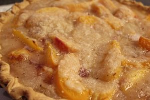 Blushing Peach Pie with fresh peaches and crumb topping