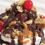 Brie with nuts, cherries and sauce