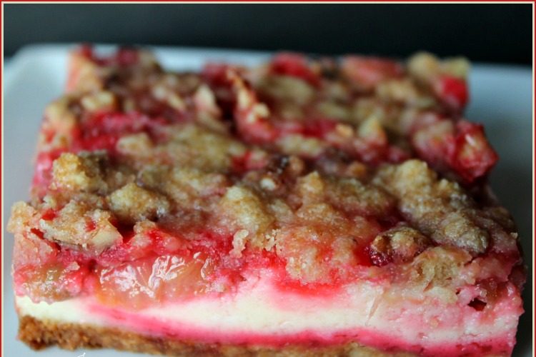 Rhubarb Cheesecake Bars -- A Pinch of Joy Sweet tangy rhubarb on a cheesecake with a nutty crust and struesel topping